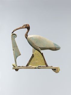 a statue of a stork with a long beak