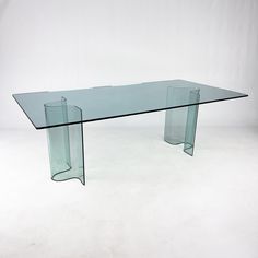 a glass table sitting on top of a white floor