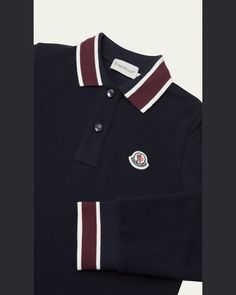 Moncler polo shirt with the classic logo bell emblem at the chest    Collared neckline    Long sleeves    Button placket    Banded cuffs     Contrast trim    Pullover style    Cotton/elastane    Machine wash cold    Imported Classic Tops With Polo Collar And Striped Cuffs, Classic Top With Polo Collar And Striped Cuffs, Classic Tops With Striped Cuffs And Polo Collar, Navy Tops With Striped Collared Neckline, Navy Tops With Striped Collar, Navy Top With Striped Collared Neckline, Black Collared Tops With Striped Cuffs, Designer Tops With Button Cuffs And Collar, Black Collared Top With Striped Cuffs