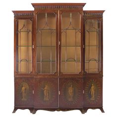 an old wooden china cabinet with glass doors and carvings on the front, side panels