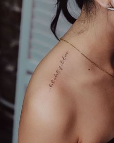 the back of a woman's shoulder with writing on it