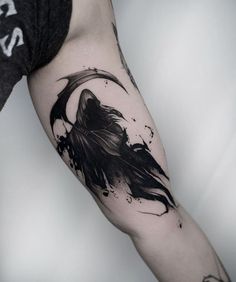 a man's arm with a black and white tattoo on it