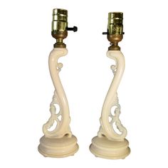 a pair of white glass candlesticks sitting on top of each other