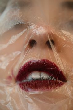 a woman's lips are wrapped in plastic