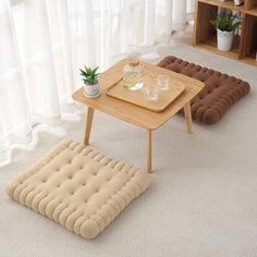 a living room with two couches and a coffee table in front of a window