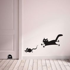 an image of a cat and mouse wall decal in a room with white walls