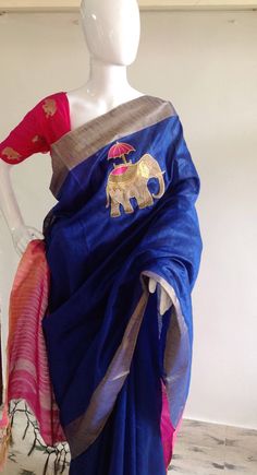 "Gorgeous royal blue and pink semi silk saree with intricate elephant hand embroidery and silk brocade unstiched blouse in pink with matching elephant weave. The hot pink color of the blouse is simply stunning when paired with royal blue of the saree. Beautiful elephant zardosi work makes this a stunning piece. Saree length 5.5 meters Blouse fabric 1 meter 44\" wide Saree ships in 2-3 days of payment.Shipping time is 4-5 days with tracking. We also offer blouse and petticoat stitching for saree Blue Embroidered Tissue Silk Blouse Piece, Embroidered Blue Tissue Silk Blouse Piece, Blue Slub Silk Blouse Piece For Festivals, Blue Handloom Tissue Silk Blouse Piece, Blue Tussar Silk Blouse Piece With Motifs, Blue Tussar Silk Saree With Embroidery, Blue Embroidered Tussar Silk Saree, Elephant Hand Embroidery, Gold Sequin Blouse