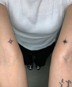 two people with tattoos on their legs and one has the word love written in cursive writing