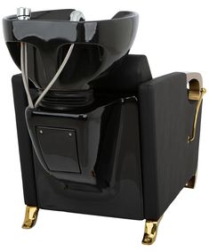 a black chair with gold legs and a bowl on it