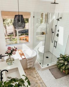 a bathroom with a tub, sink and shower