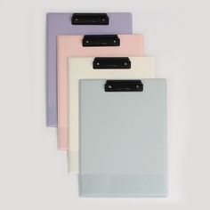 three clipboards with black clips on them are lined up against a white background and one is empty