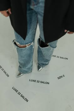 a person standing on top of a piece of paper that has been cut out and put in their jeans