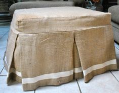 a tan ottoman with a white stripe on it