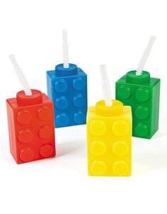 four lego style toothbrushes in different colors and sizes with straws on them