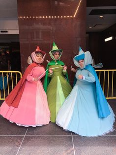 three women dressed in costume standing next to each other