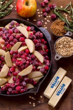 apples, raspberries and oatmeal in a skillet on a table