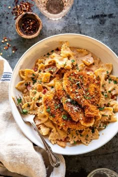 a white bowl filled with pasta and meat