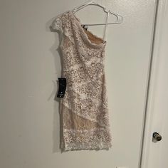 Brand New Tags Still On. Lace One Shoulder Dress Size Small. White One-shoulder Lace Dress, White Lace Mini Dress For Evening, White Mini Lace Dress For Night Out, White One-shoulder Mini Dress, Elegant One Shoulder Lace Mini Dress, White Lace Dress For Spring Night Out, One Shoulder Mini Dress, Bebe Dresses, White Cream