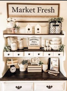 a white dresser topped with shelves filled with boxes and other items on top of it