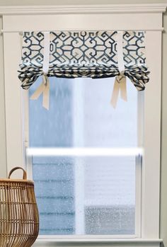 a window sill with a basket next to it and a curtain in the window