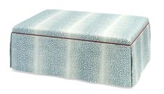 a blue and white ottoman with red piping on the top, sitting against a white background