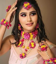 a woman with flowers in her hair and jewelry