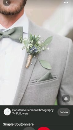 a man wearing a gray suit with a boutonniere on his lapel