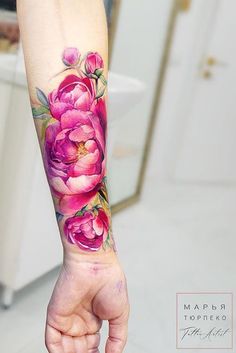 a woman's arm with pink flowers on it