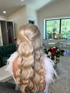 the back of a woman's head with long blonde hair