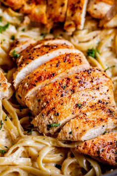 chicken and pasta in a skillet with parsley on the side, ready to be eaten