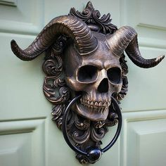 a skull mounted to the side of a door with horns on it's head