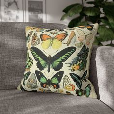 a pillow with butterflies on it sitting on a couch