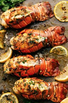 grilled lobsters with lemon wedges and parsley