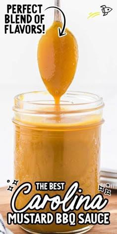 the best carolina mustard sauce in a glass jar with a spoon sticking out of it