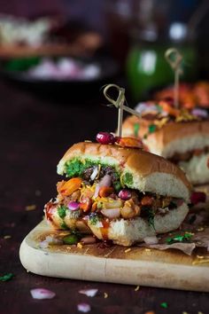 two sandwiches with toppings sit on a cutting board next to confetti and sprinkles