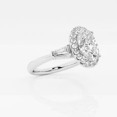 an oval cut diamond ring with baguetts on the shoulders