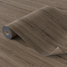 a roll of wood flooring on the ground