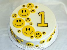 a happy birthday cake with smiley faces on it