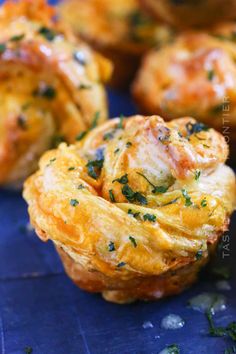 mini quiches with cheese and herbs on a blue surface