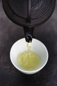 a small white bowl filled with green liquid