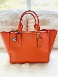 Coach Crosby Carryall in Smooth leather crossbody tote bag in orange brand new with tag, this bag is almost in perfect condition, was never touched or used. Comes with original dust bag . There are two ways of shaping this bag, very versatile! roomy and elegant. COACH STYLE # 59183E Details Calf leather Inside zip, cell phone and multifunction pockets Zip-top closure, fabric lining Handles with 6" drop Long strap with 22" drop for shoulder or crossbody wear 17" (L) x 9 3/4" (H) x 7" (W) MSRP $395.00 This is not an outlet item, high quality of everything. Orange Handbag, Branding Coach, Crossbody Tote Bag, Orange Bag, Crossbody Tote, Zip Top, Leather Crossbody Bag, Tote Handbags, Smooth Leather