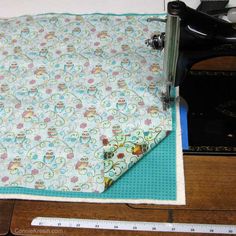 the sewing machine is on top of the table next to the quilter's piece