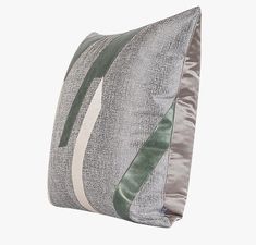 a gray and green pillow on a white background with a black stripe down the middle