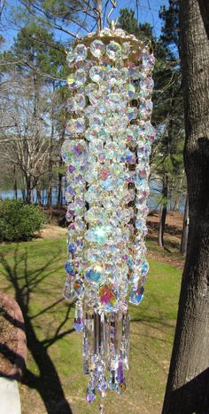 a chandelier hanging from the side of a tree