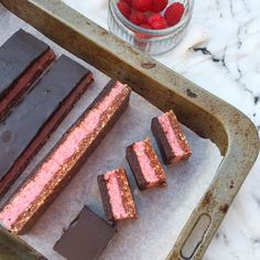 chocolate and raspberry desserts on a baking sheet