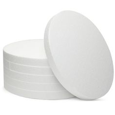 four white round foam pads stacked on top of each other in front of a white background