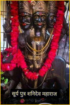 a statue with red garlands around it