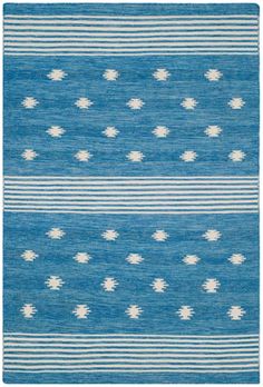 a blue and white rug with small dots on the bottom, in different sizes and colors