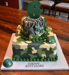 a camouflage birthday cake with the number three on it's top and army themed decorations