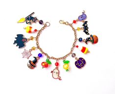 This happy and colorful Halloween charm bracelet is handcrafted by myself, and contains an assortment of enamel charms.  The gold plated chain is 7 3/4 inches long with 13 charms containing  jack o lanterns, ghosts,  bat, cats, and candy corn.  If you need it shorter or longer just let me know, and I will adjust it to as close as possible to the size you desire. If you would like a charm switched to something else just ask!  Each charm is placed with thought  for color and balance.  It is  a rea Novelty Multicolor Charm Bracelet, Multicolor Themed Jewelry With Charms, Themed Multicolor Jewelry With Charms, Multicolor Novelty Bracelets For Halloween, Multicolor Themed Charm Bracelet As Gift, Fun Multicolor Halloween Jewelry, Handmade Halloween Charm Bracelet Gift, Handmade Charm Bracelet For Halloween Gift, Candy Corn Pumpkin